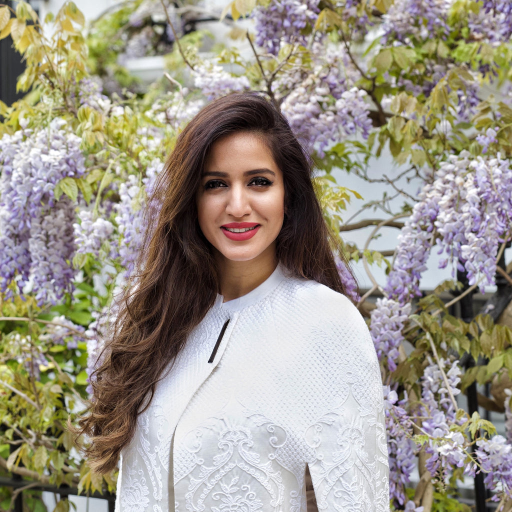 A photo of the Founder in Notting Hill against a background of Spring Wisteria