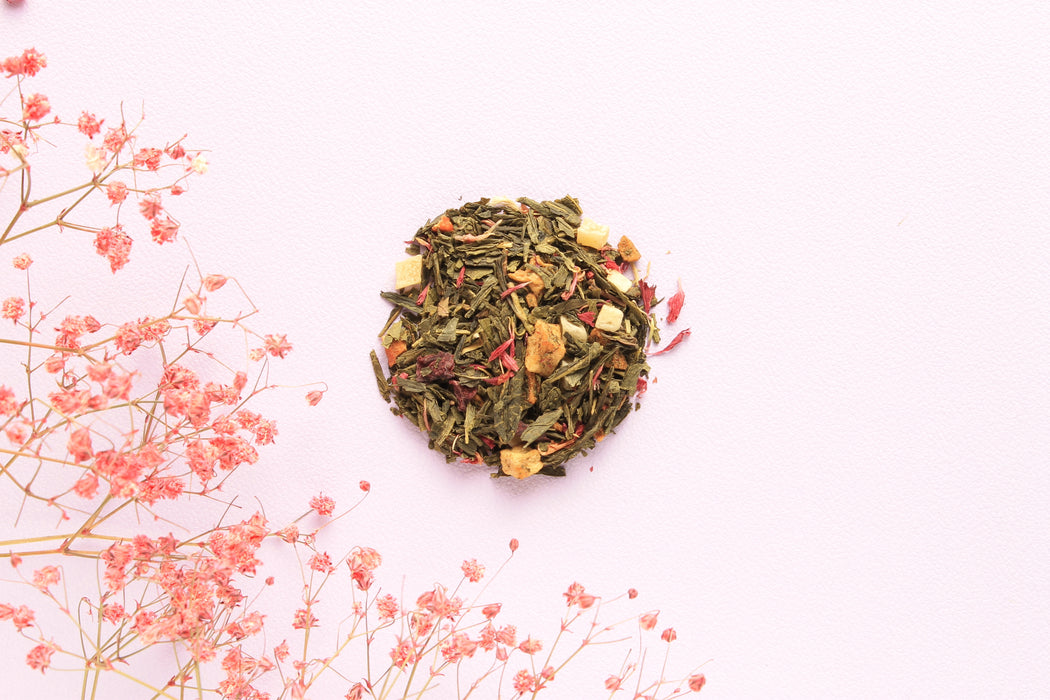 The loose leaves of sencha tea with guava, mango blocks, apples, mango slices, beetroot and pink popcorn