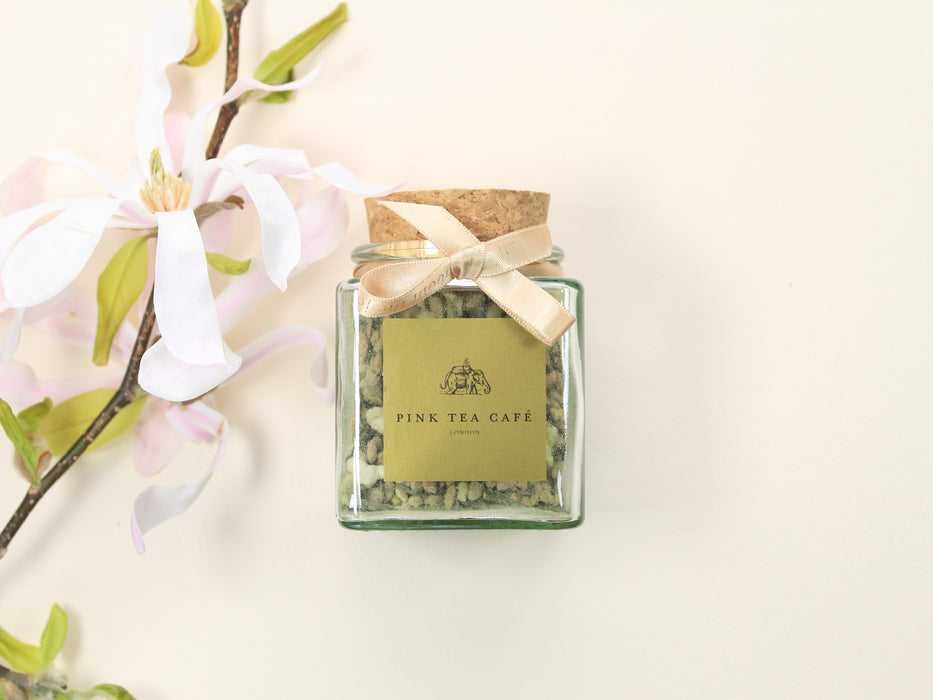 Square glass jar with a golden ribbon filled with Japan Matcha Genmaicha 