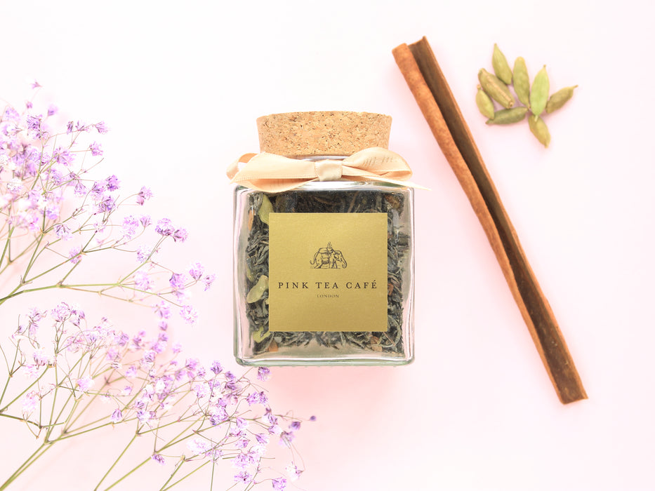 Beautiful square glass jar with a golden ribbon, filled with Pure Green Chai