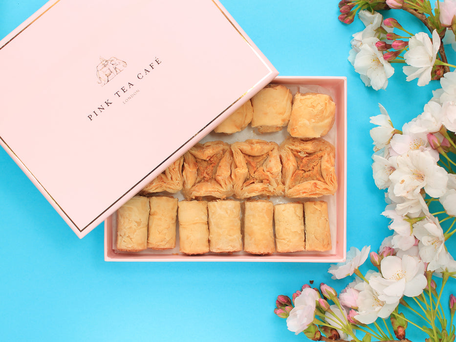 Luxury branded, pink box with delicious regular baklava pieces, decorated with white flowers